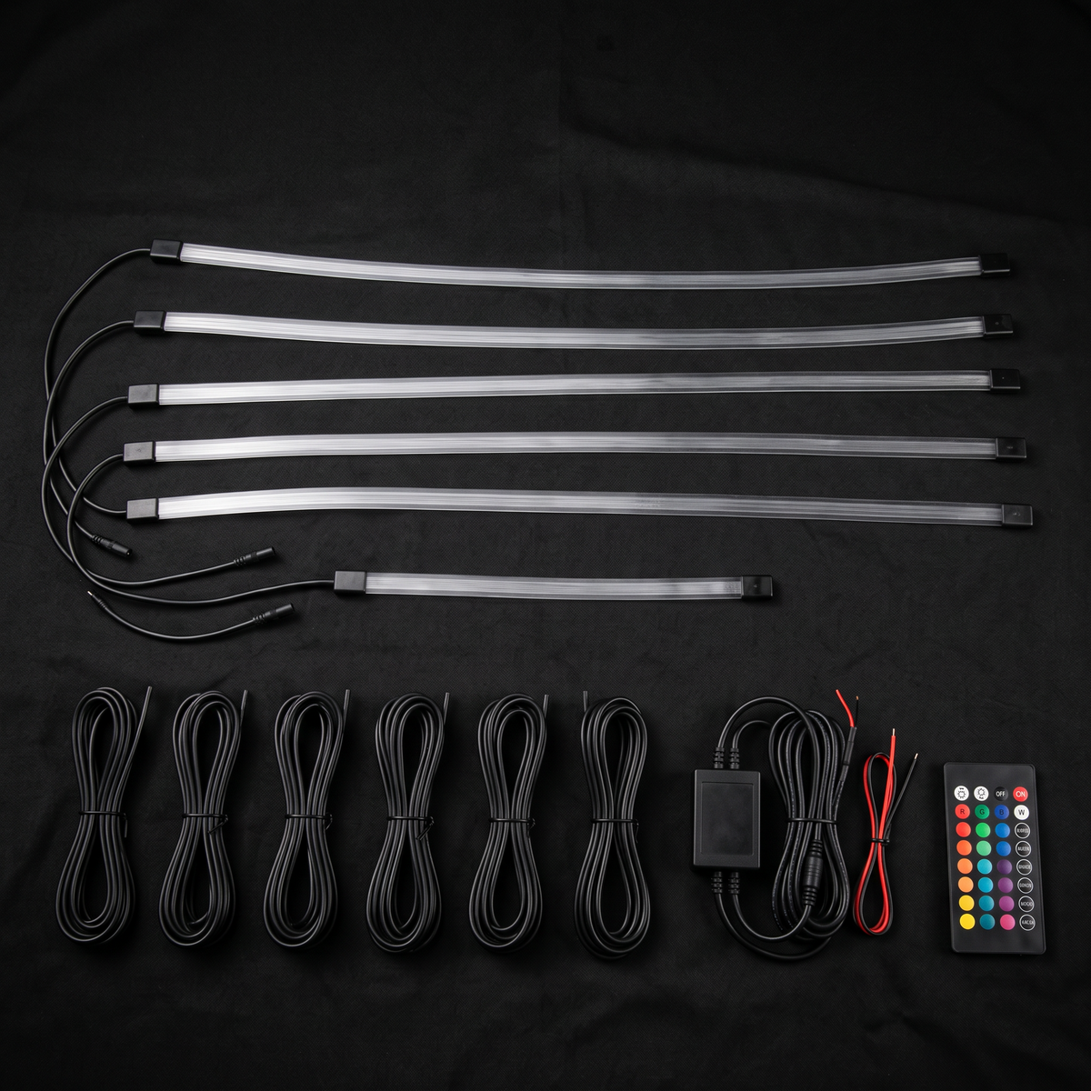 Ambient interior light kit contents: six fibre optic strips, six extension wires, controller and remote