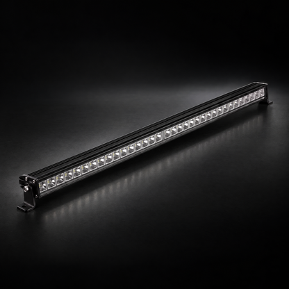 32 inch Whipped 4WD RGB LED light bar, lights off, black aluminium housing and end brackets on a dark studio floor